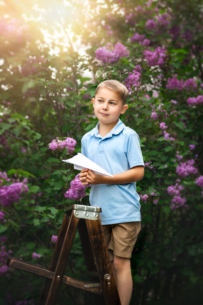 This image has an empty alt attribute; its file name is boy-paper-airplane-lilacs-childhood-nostaglic-boyhood-1-683x1024.jpg